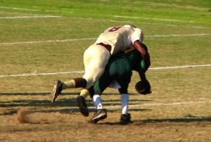 stock image of football player being tackled